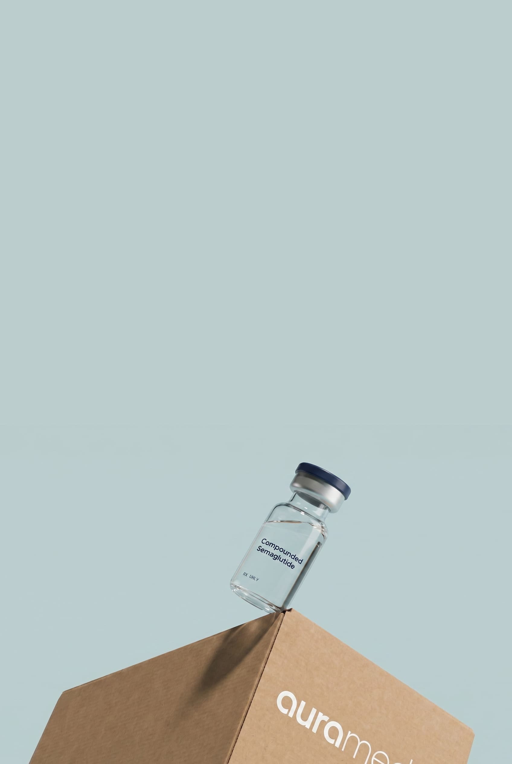 Compounded semaglutide vial resting on an aurameds box